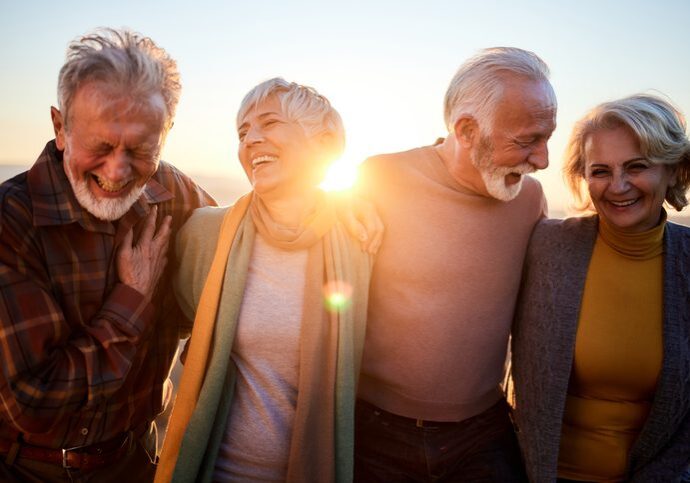 Happy mature couples talking while walking in autumn day.
