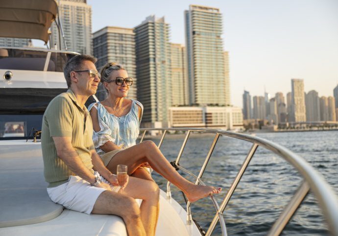 Relaxed mature expatriate couple on luxury yacht looking at view